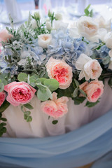Dinner tables in the restaurant decorated with white and pink flowers