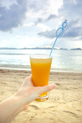 Fresh mango cocktail with a beautiful view on the beach