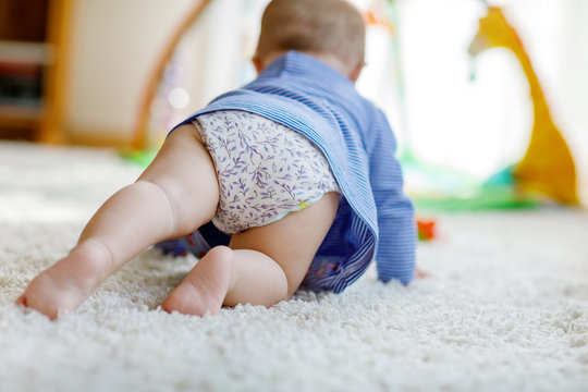 Little cute baby girl learning to crawl.