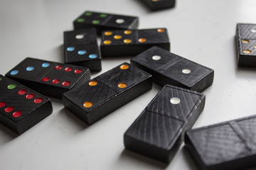 Black dominoes with colorful dots