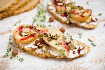 Bread with ricotta cheese and pears on the wooden background. Shallow depth of field.