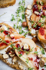 Bread with ricotta cheese and pears on the wooden background. Shallow depth of field.