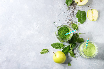 Variety of three color green spinach kale apple yogurt smoothie in mason jars with retro cocktail...