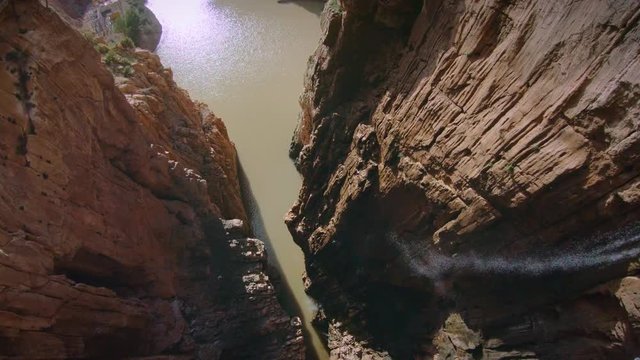 Wide angle shot on beautiful and inspiring canyon with pure natural waterfall falling down into mountain river stream. Breathtaking and inspring travel destination for explorers and bloggers