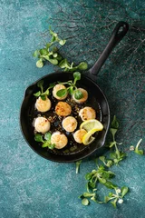 Foto op Plexiglas Fried scallops with butter lemon spicy sauce in cast-iron pan served with green salad over turquoise texture background. Top view, copy space © Natasha Breen