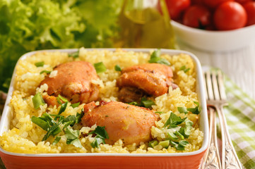 Oven baked chicken meat with rice.