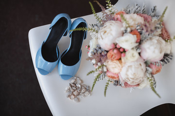 Elegant wedding flower bouqet on texture background with bridal shoes tiffany colour