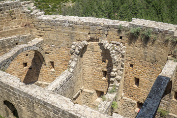 Ruined remains of the interior of an ancient medieval castle, part of the half barrel vault roof, or tunnel vault, or wagon vault. And a semicircular arch Romanesque architecture