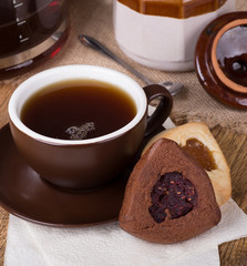 Raspberry Filled Hamantash Cookie and Cup of Coffee