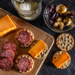 cheese, crackers, sausage and olives for snacking