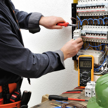 Elegant electrician technician at work on a residential electric panel