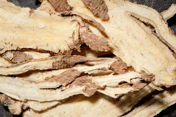 Chinese herbal medicines -- Angelica slices on stone background
