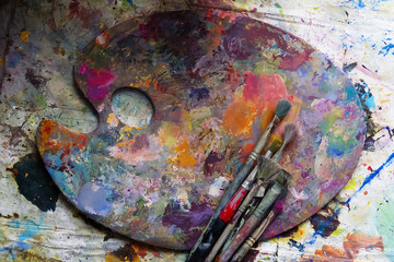 workplace painter palette with colors and brushes. Palette of colors, creative disorder, art