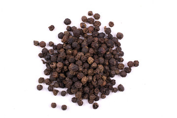 A pile of a  dry black pepper seeds isolated on white background