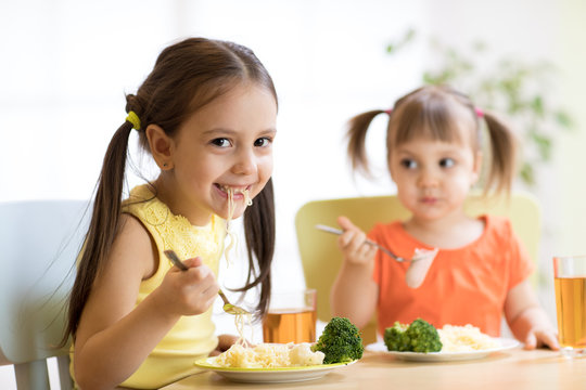 Children eating healthy food in nursery or at home