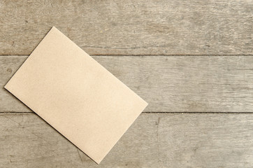 Envelope letter on wooden table.