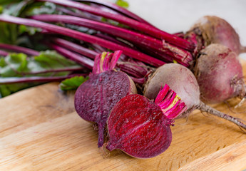 Young raw red beets roots with leaves