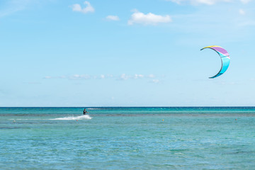 A kite surfer rides the waves