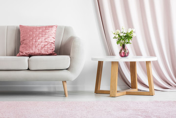 Pink pillow on beige sofa