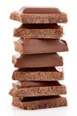 Milk chocolate pieces isolated on white background.