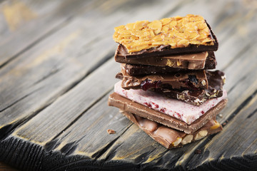 Mix of sweet swiss choccolate on the wooden table