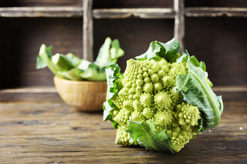 Raw fresh Roman cauliflower on the wooden table