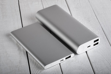 battery bank for charging mobile devices. Silver smart phone charger with power bank. External...
