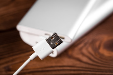 battery bank for charging mobile devices. Silver smart phone charger with power bank. External battery for mobile devices.