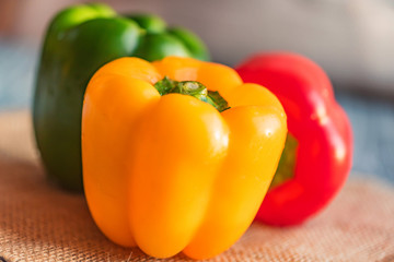Variety of bell paprika peppers on cutting board