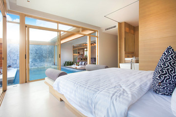 Luxury Interior design in bedroom of pool villa with cozy king bed. Bedroom with high raised ceiling 