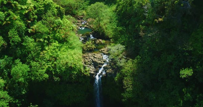 Cinematic aerial view of beautiful waterfall in Hawaii