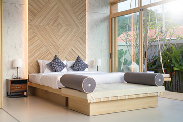 Luxury Interior design in bedroom of pool villa with cozy king bed. Bedroom with high raised ceiling 