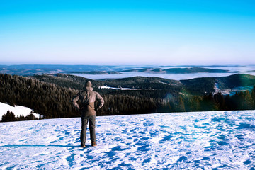 Man trekking in mountains in winter.