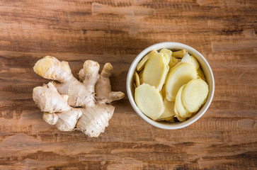 ginger on wood background, ginger sliced