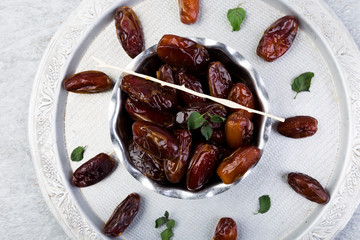 Dry fruit dates on silver tray. Copy space.