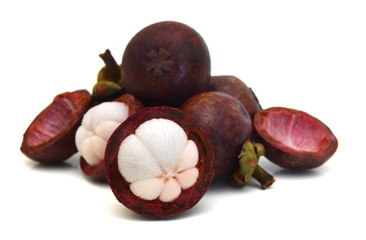 Mangosteen fruit and cross section showing the thick purple skin and white flesh of the queen of fruits.