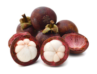 Mangosteen fruit and cross section showing the thick purple skin and white flesh of the queen of fruits.