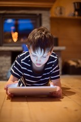 Eight years old boy using digital tablet