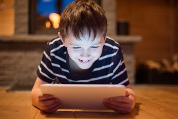Eight years old boy using digital tablet