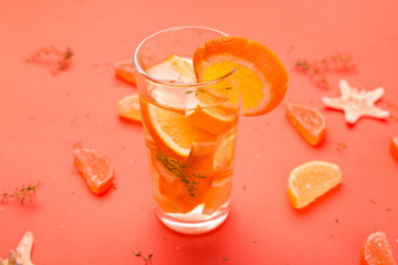 Orange fruit cocktail, detox water on orange background.