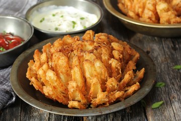 Homemade Blooming Onion with dipping sauce, selective focus