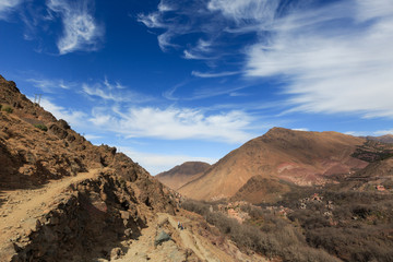 Atlas Mountains. Mountain panorama of walking hiking trail. Morocco, winter. Wild nature landscape. Village in the valley.