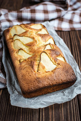 Delicious homemade pear pie on a wooden background