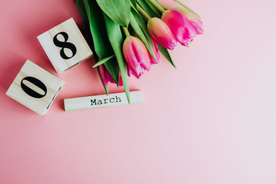 8 March Happy Women's Day concept. With wooden block calendar and pink tulips on pink background. Copy space - Powered by Adobe
