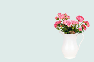 Pink flowers in white jug.