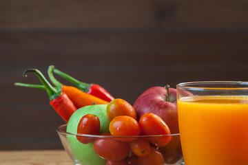 Healthy concept with mixed fruits and vegetables on wooden background