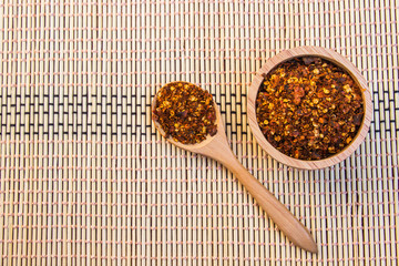 Spiced cayenne pepper in wooden bowl. Top view