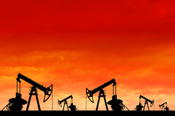 Silhouette of oil pumps at sunset.