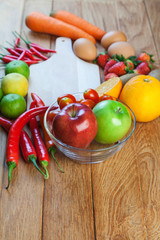 Healthy concept with mixed fruits and vegetables on wooden background