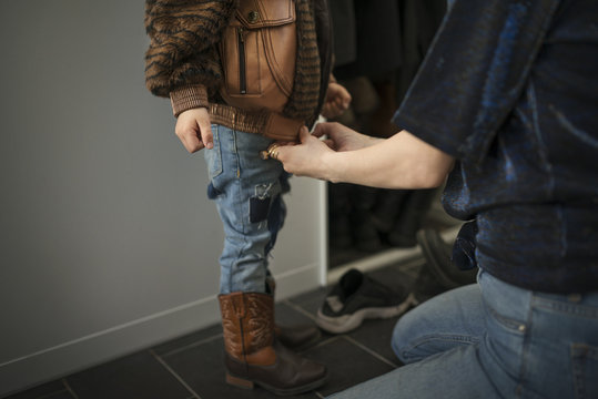 Mother dressing son